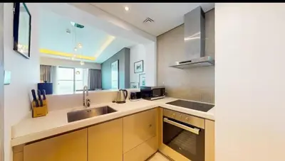 a kitchen with a sink and a counter top at Moderne 1BR apartment overlooking city in Dubai