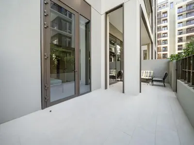 an empty hallway of a building with glass doors at Modern 1-Bed Escape with Large Terrace, Creek Beach Dubai in Dubai