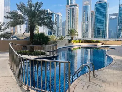 a swimming pool in a city with tall buildings at Vacationer I Premium 1 Bed I Dubai Marina Living & Metro Nearby I Dream Tower in Dubai