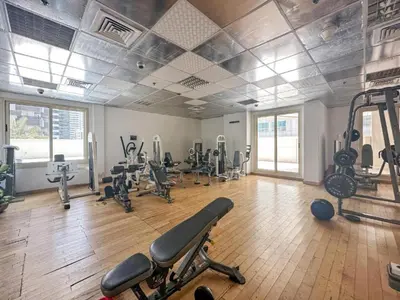 a gym with treadmills and machines in a room at Vacationer I Premium 1 Bed I Dubai Marina Living & Metro Nearby I Dream Tower in Dubai
