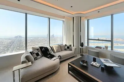 a living room with a couch and a table at Palm Tower - Luxurious One Bed with Palm View in Dubai