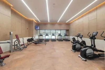 a gym with a bunch of treadmills and exercise bikes at Palm Tower - Luxurious One Bed with Palm View in Dubai