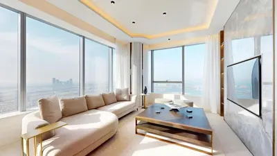 a living room with a couch and a tv at Palm Tower - Luxurious One Bed with Palm View in Dubai