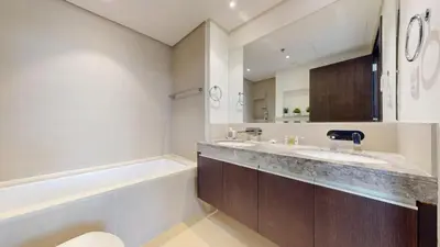 a bathroom with a sink and a bath tub at Creek Residences - One Bedroom with Creek View in Dubai