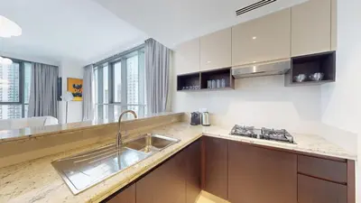 a kitchen with a sink and a counter top at Creek Residences - One Bedroom with Creek View in Dubai
