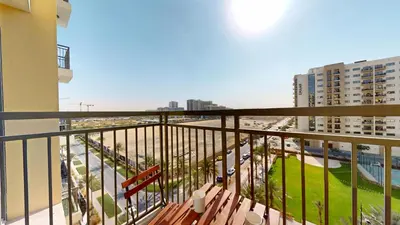 a balcony with a bench and a view of a city at UNA Tower - Peaceful One Bedroom in Townsquare in Dubai