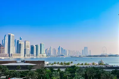 a view of a city skyline with a body of water at Seven Palm Residences - Private Beach Access, Infinity Pool with Sea View in Dubai
