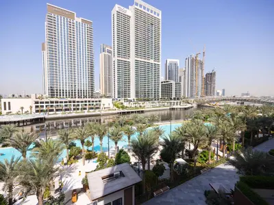 a view of a city with a pool and palm trees at Beach View family friendly unit in Dubai in Dubai