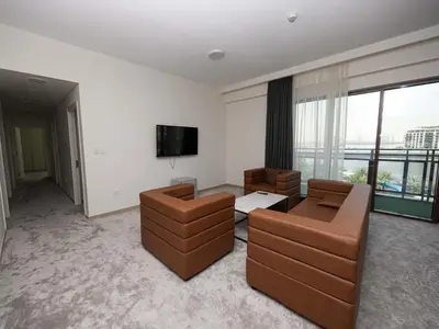 a living room with two couches and a flat screen tv at Beach View family friendly unit in Dubai in Dubai