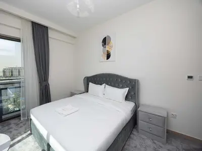 a bedroom with a white bed and a window at Beach View family friendly unit in Dubai in Dubai