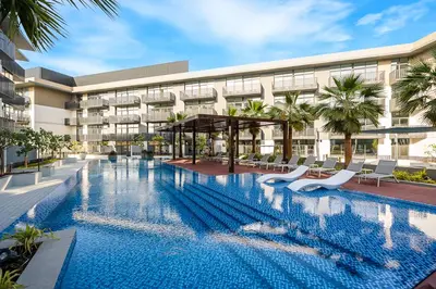an image of a swimming pool in front of a building at Stylish 2BR Apartment in Belgravia III A, JVC - Allsopp & Allsopp in Dubai