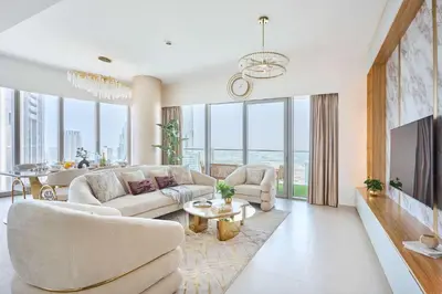 a living room with a couch and a table at Frank Porter - Grande Signature Residence in Dubai