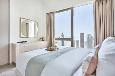 a bedroom with a large bed with a large window at Frank Porter - Grande Signature Residence in Dubai