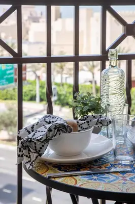 a table with a bowl and a bottle of water at Frank Porter - Lamtara 3, MJL in Dubai