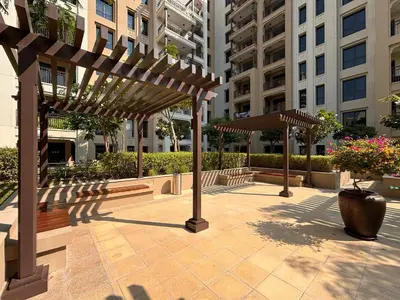 a group of wooden pergolas in front of a building at Frank Porter - Lamtara 3, MJL in Dubai