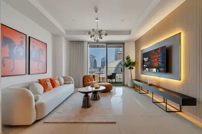 a living room with a couch and a table at Trendy 1BR Dubai Dream with full BurjViews Above Dubai Mall in Dubai