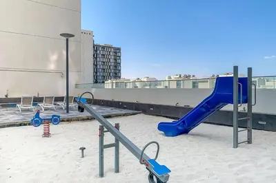 a playground with a blue slide on a building at Frank Porter - Pulse Residence Park B3 in Dubai