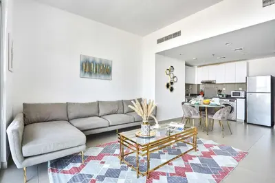 a living room with a couch and a table at Frank Porter - Pulse Residence Park B3 in Dubai