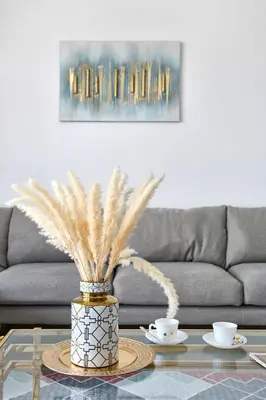 a living room with a couch and a table with two cups at Frank Porter - Pulse Residence Park B3 in Dubai