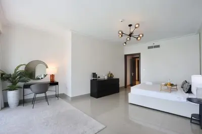 a white bedroom with a bed and a desk at 2BR with Iconic Burj and Dubai Fountain Views in Dubai