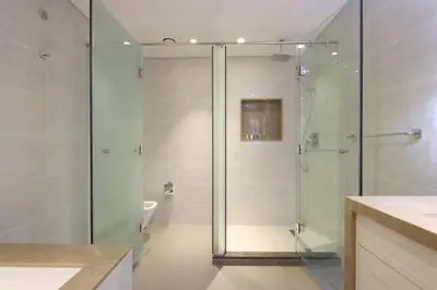 a bathroom with a glass shower and a sink at 2BR with Iconic Burj and Dubai Fountain Views in Dubai
