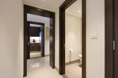 a bathroom with a toilet and a mirror at 2BR with Iconic Burj and Dubai Fountain Views in Dubai