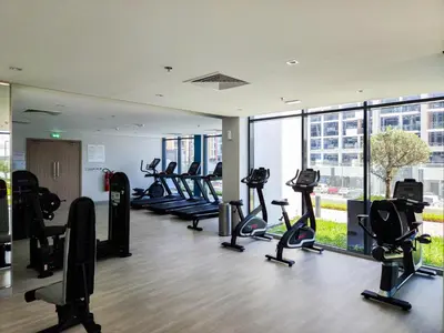 a gym with treadmills and ellipticals in a building at Modern Elegance in a Cosy Retreat with Balcony - Azizi Riviera in Dubai