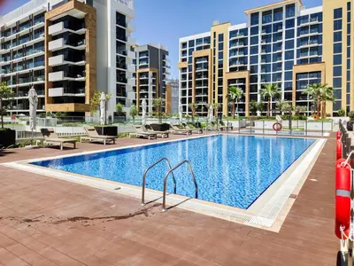 a large swimming pool with buildings in the background at Modern Elegance in a Cosy Retreat with Balcony - Azizi Riviera in Dubai