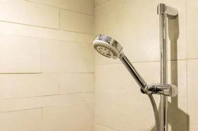 a shower with a shower head in a bathroom at Modern Elegance in a Cosy Retreat with Balcony - Azizi Riviera in Dubai