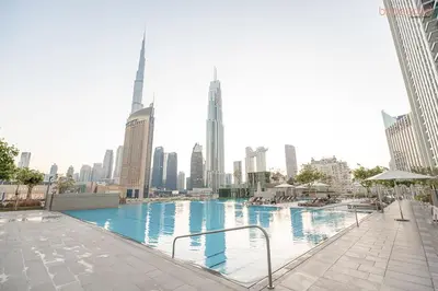 a large swimming pool in the middle of a city at Bnbeyond's Artistic Luxe Retreat with Burj Views in Dubai
