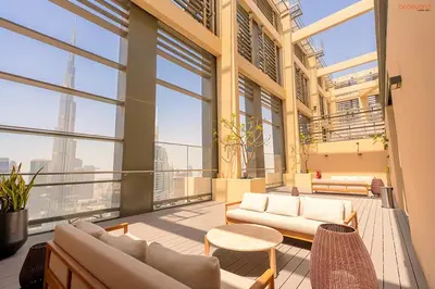 a living room with couches and tables in a building at Bnbeyond's Sky-High Luxe with Above and Beyond Views in Dubai