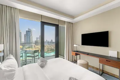 a hotel room with a bed and a flat screen tv at Address Residence Dubai Opera 34 by Luxstay Holiday Homes in Dubai