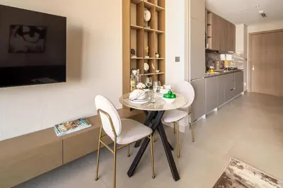 a kitchen and dining room with a table and chairs at Frank Porter - Westwood Grande in Dubai