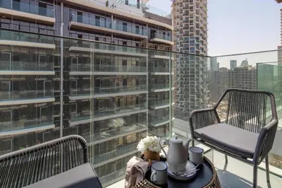 a balcony with a table and a chair on a building at Frank Porter - Westwood Grande in Dubai
