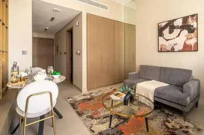 a living room with a couch and a table at Frank Porter - Westwood Grande in Dubai