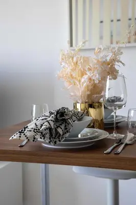 a table with a plate and glasses on a table at Frank Porter - West Avenue in Dubai