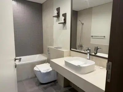 a bathroom with a sink and a tub and a toilet at Dubai Frame Views Steps from Metro & Sheikh Zayed Road in Dubai