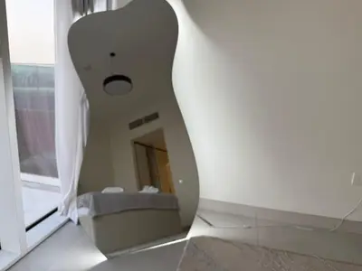 a mirror in a white room with a window at Dubai Frame Views Steps from Metro & Sheikh Zayed Road in Dubai