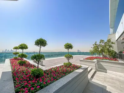 a garden with pink flowers and trees on a building at Dubai Frame Views Steps from Metro & Sheikh Zayed Road in Dubai