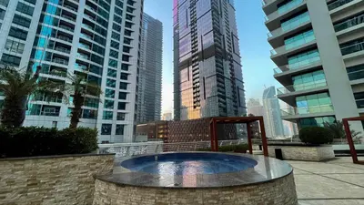 a fountain in a city with tall buildings at Charming 1BR with Sea & City Views in Dubai