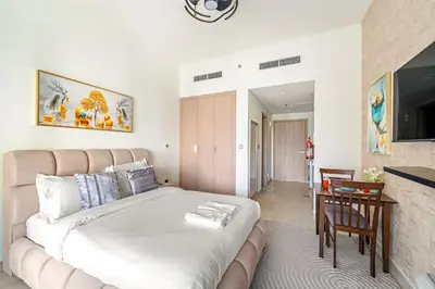 a bedroom with a large bed and a dining room at FIRST CLASS Studio Modern Vibes in Dubai in Dubai