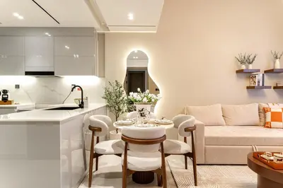 a kitchen and living room with a table and a couch at Burj et Canal View Sunny Pool in Dubai