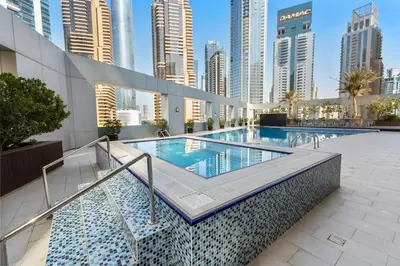 a swimming pool in a city with tall buildings at Modern 1BR JBR View No Car Needed! in Dubai