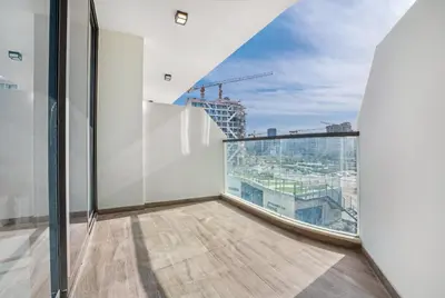 an apartment balcony with a view of a city at Chic One-Bed Haven w Pool & Gym Heart of Dubai in Dubai