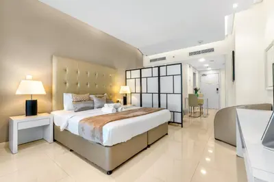 a large bedroom with a large bed and a bathroom at Live the Dubai Dream Premium Flat in Business Bay in Dubai