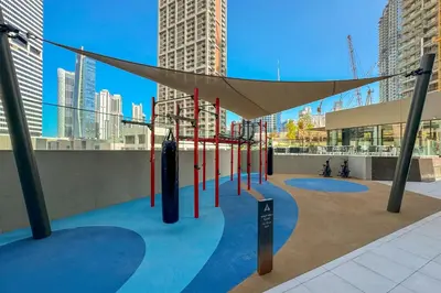 a playground in a city with tall buildings at Modern 1Bedroom w Burj Khalifa view in Peninsula in Dubai
