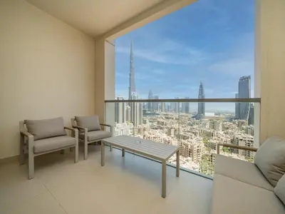 a living room with a view of a city at Modern Downtown 2 Bed plus Maids with Full Burj View in Dubai