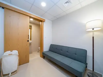 a blue couch in a room with a bathroom at Modern Downtown 2 Bed plus Maids with Full Burj View in Dubai