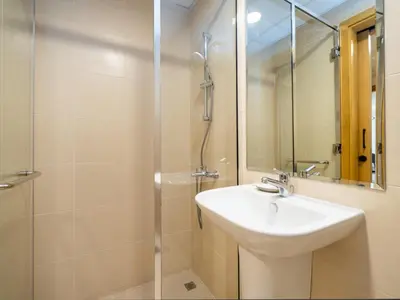 a bathroom with a sink and a shower at Modern Downtown 2 Bed plus Maids with Full Burj View in Dubai