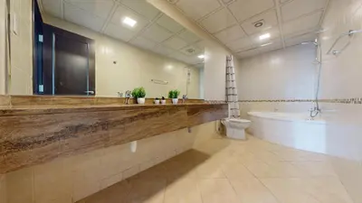 a bathroom with a sink and a tub and a toilet at Royal Oceanic - Bright Two Bed on the 14th Floor in Dubai